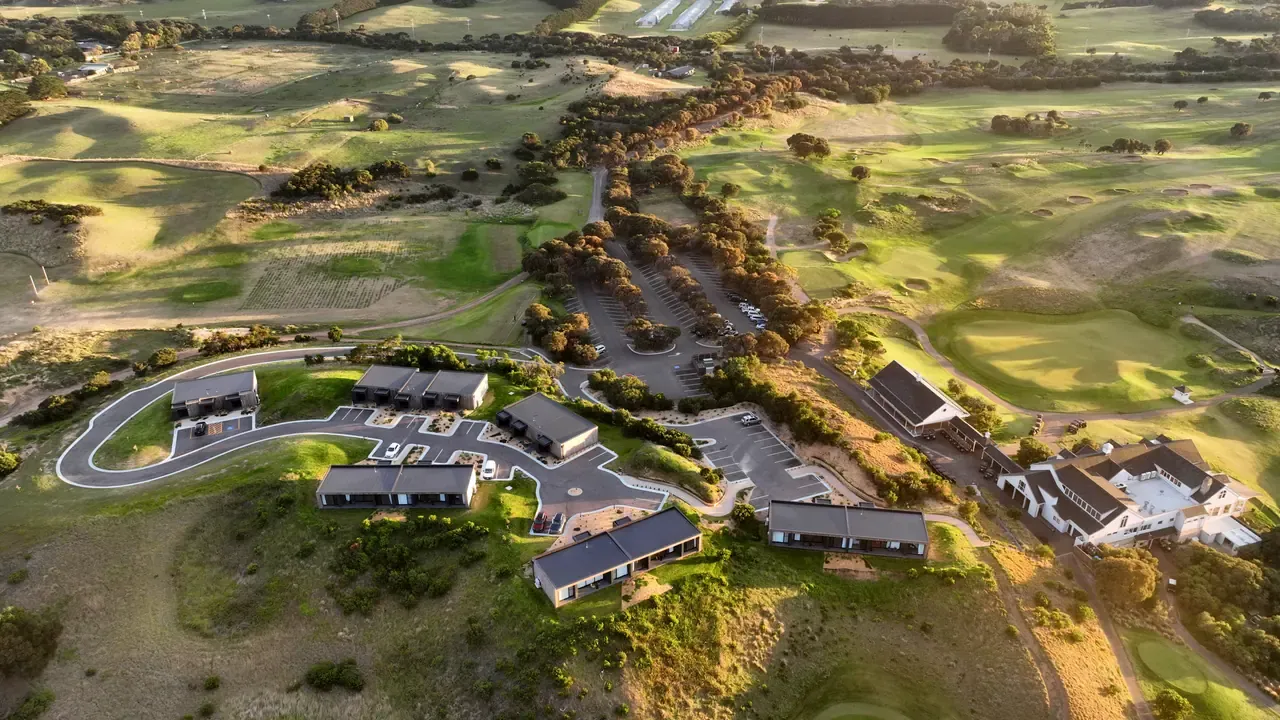 Aerial view of the clubhouse, accommodation and car park at The Dunes Golf Links, with fairways and greens stretching behind
