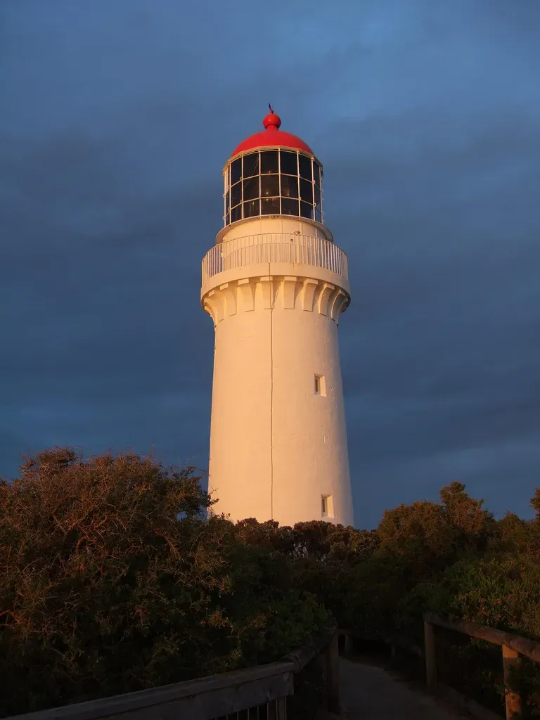 Cape Schanck lighthouse above coastal scrub at dusk